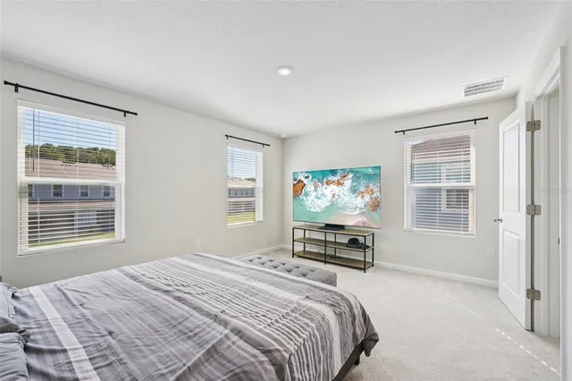 a bedroom with a bed a dresser and a window