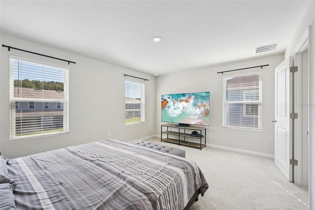 12057 Grizzly Lane New Port Richey, FL 34654 - Photo 14 of 25 a bedroom with a bed a dresser and a window
