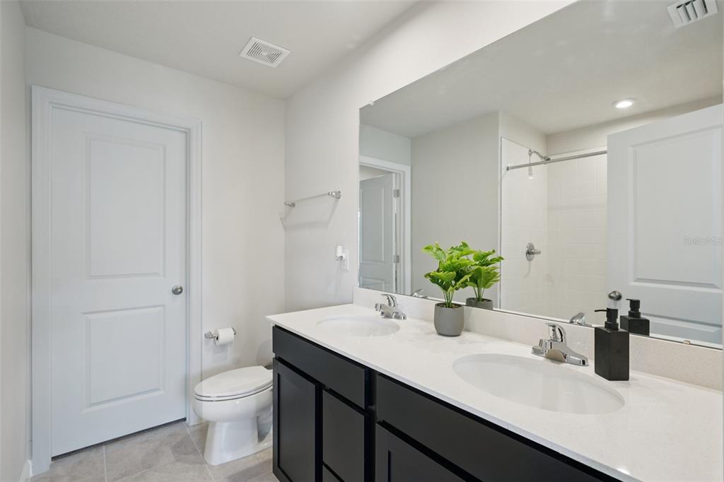 12057 Grizzly Lane New Port Richey, FL 34654 - Photo 15 of 25 a bathroom with a sink a toilet and shower