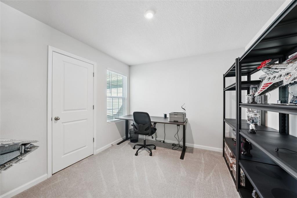 12057 Grizzly Lane New Port Richey, FL 34654 - Photo 16 of 25 a view of a workspace with furniture and a window