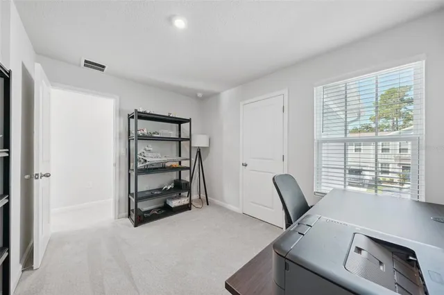 a view of workspace with furniture and window