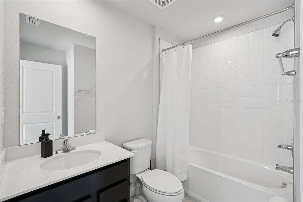 12057 Grizzly Lane New Port Richey, FL 34654 - Photo 18 of 25 a bathroom with a sink toilet and shower