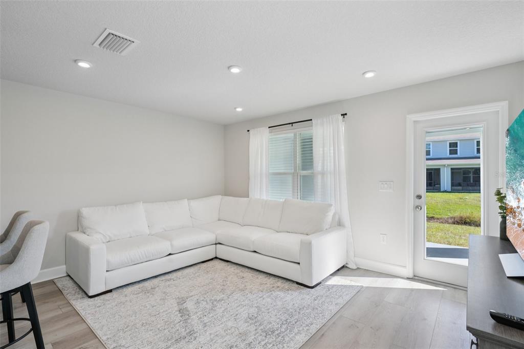 12057 Grizzly Lane New Port Richey, FL 34654 - Photo 2 of 25 a living room with furniture and a window