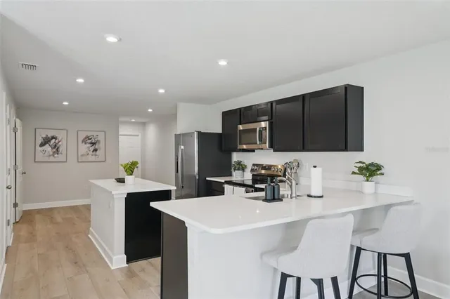 a kitchen with stainless steel appliances a sink stove and refrigerator