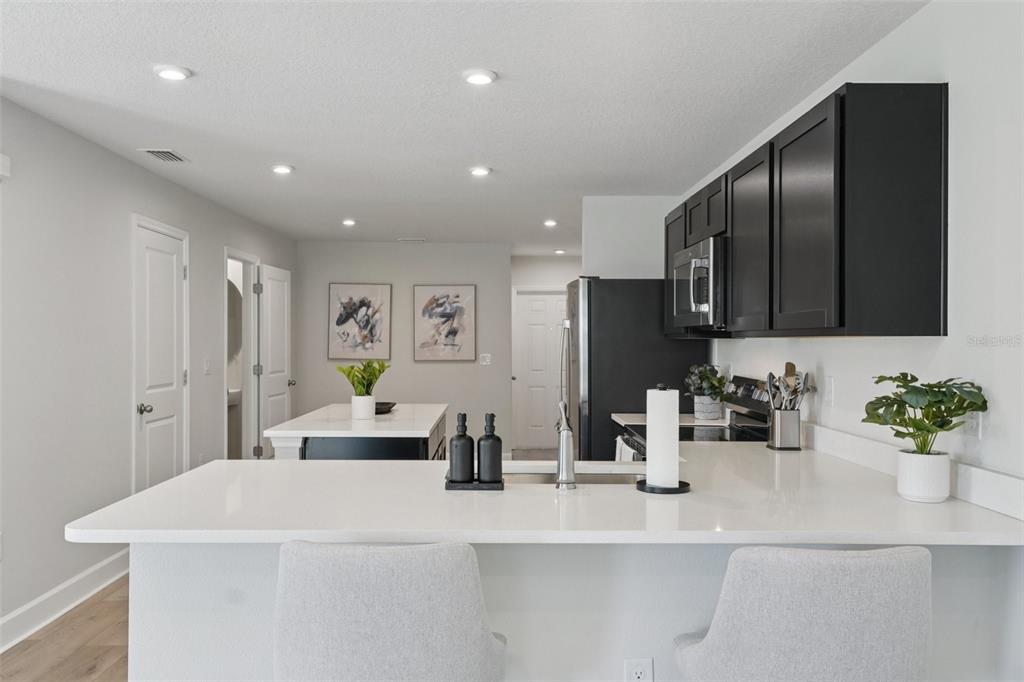 12057 Grizzly Lane New Port Richey, FL 34654 - Photo 5 of 25 a kitchen with counter top space and stainless steel appliances