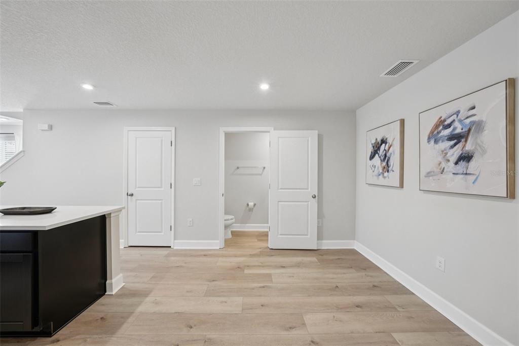 12057 Grizzly Lane New Port Richey, FL 34654 - Photo 6 of 25 a view of a room with wooden floor and cabinet