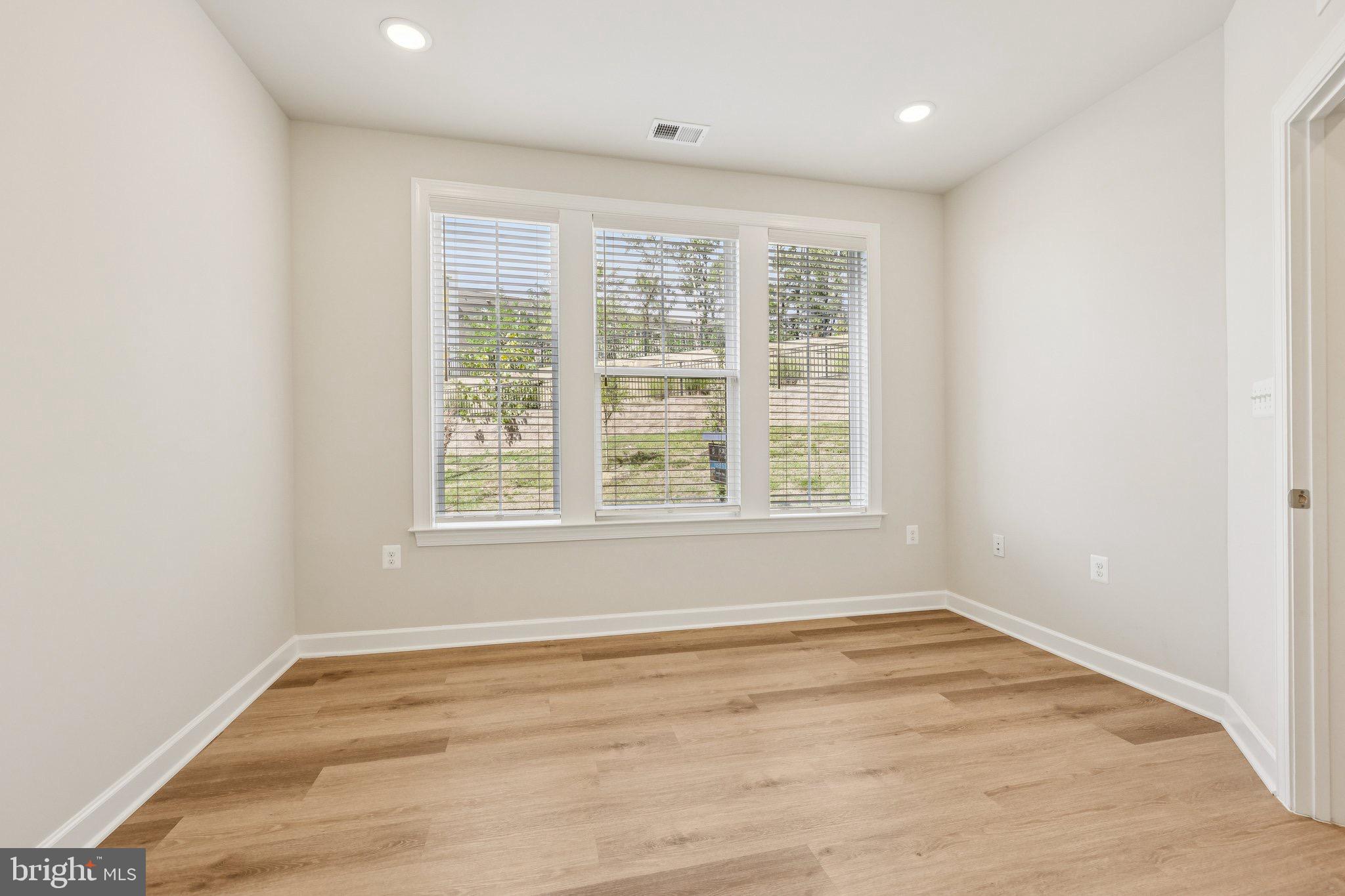 7355 Mountaineer Drive Alexandria, VA 22306 - Photo 15 of 47 an empty room with wooden floor and windows