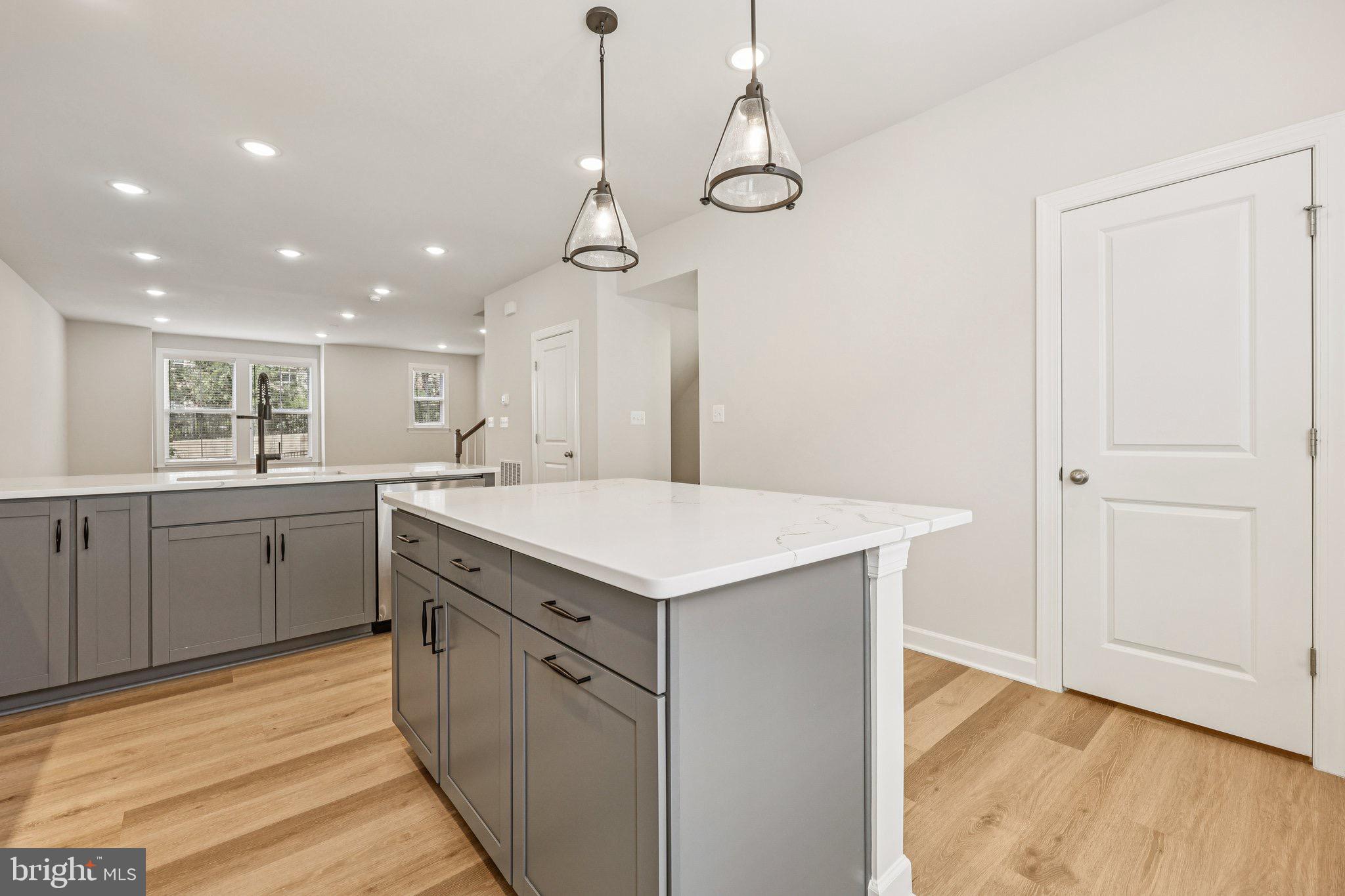 7355 Mountaineer Drive Alexandria, VA 22306 - Photo 21 of 47 a kitchen with a stove a sink a window and wooden floor