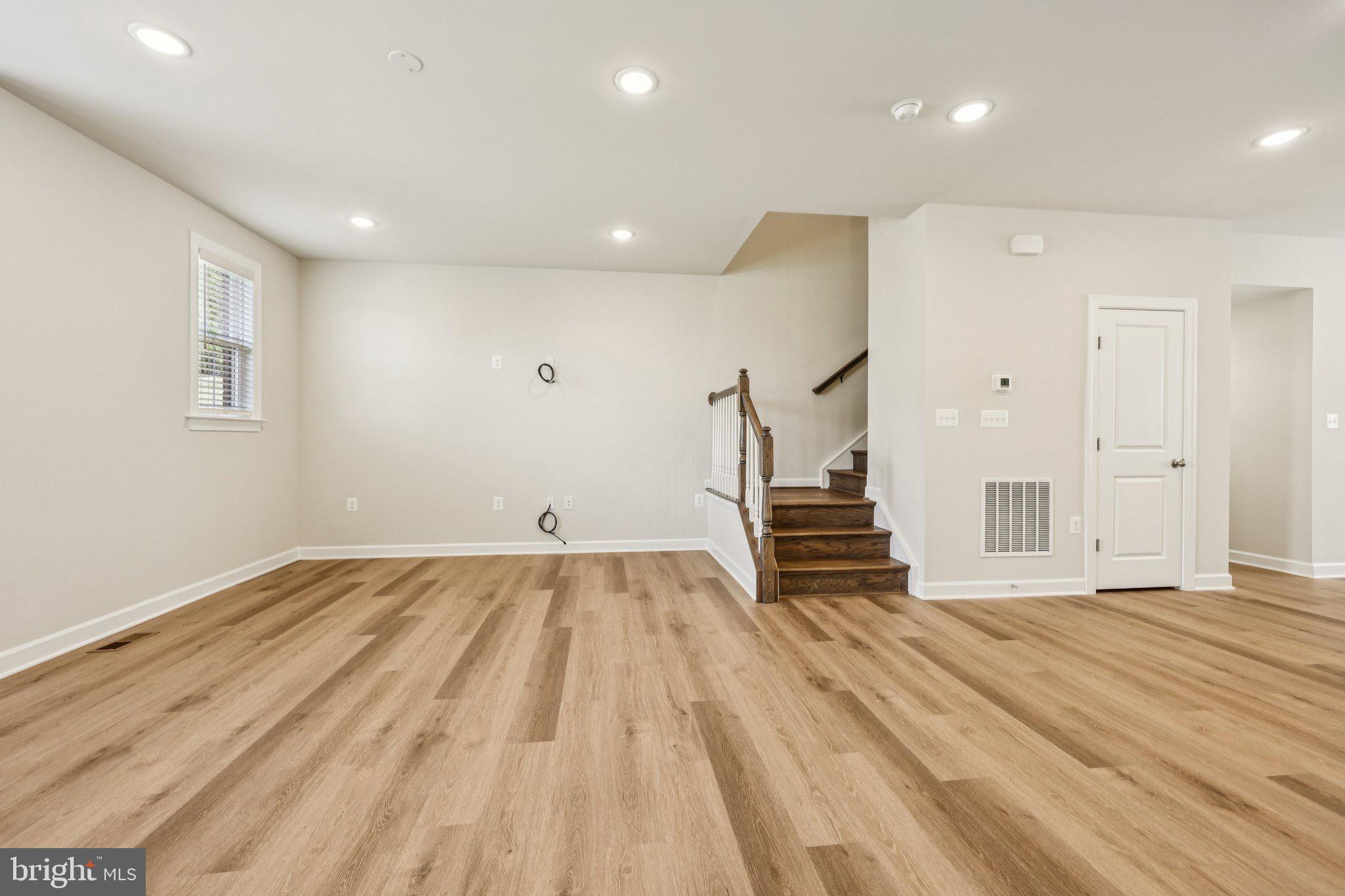 7355 Mountaineer Drive Alexandria, VA 22306 - Photo 26 of 47 a view of empty room with wooden floor and stairs