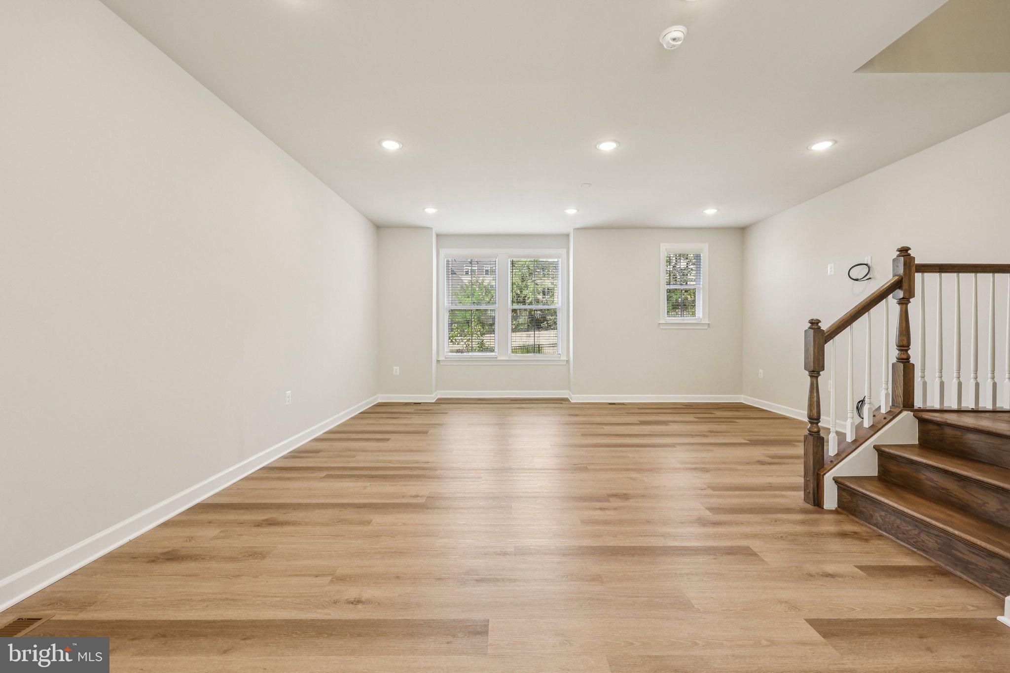 7355 Mountaineer Drive Alexandria, VA 22306 - Photo 27 of 47 a view of an empty room with wooden floor fireplace and a window