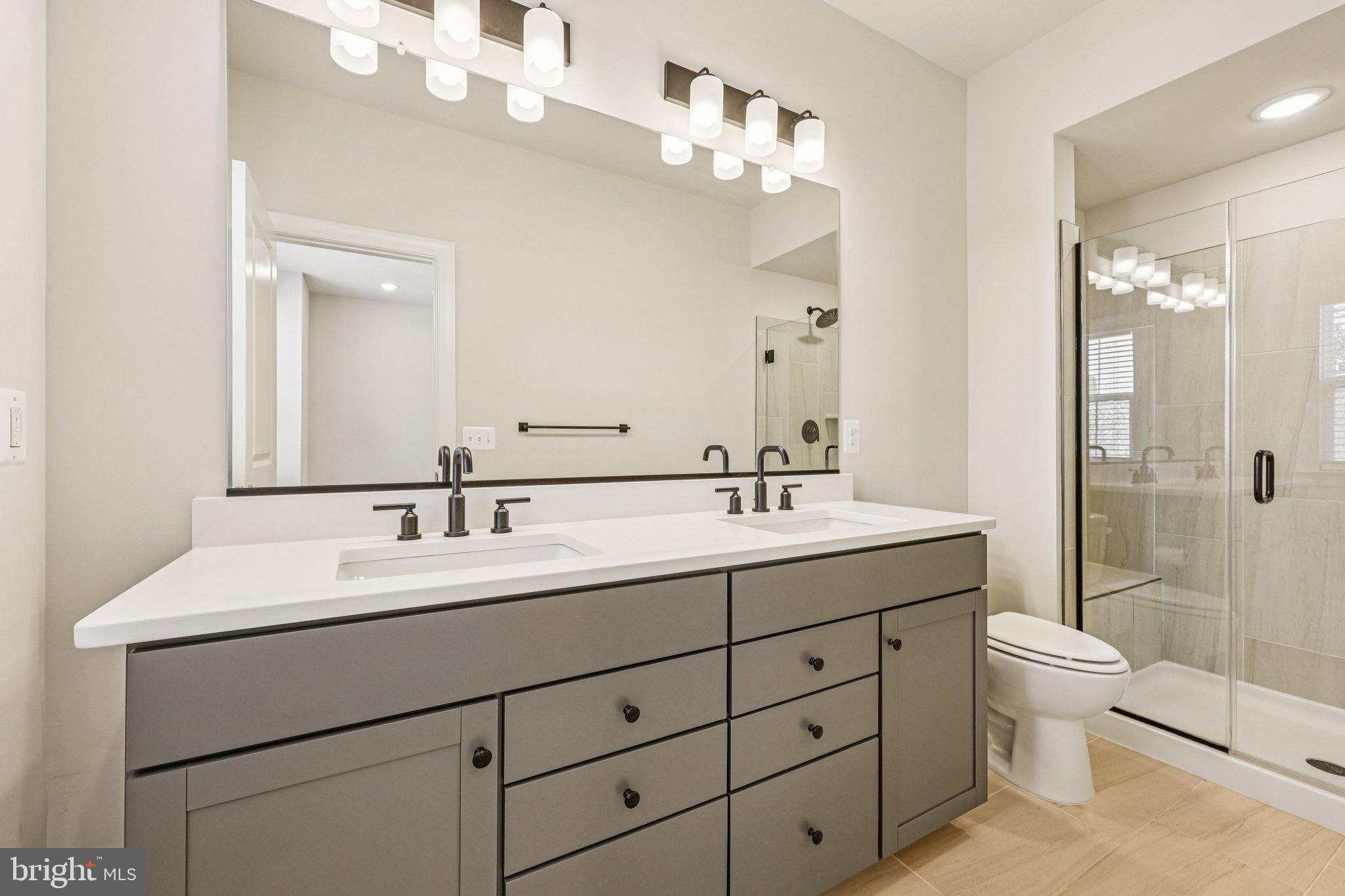 7355 Mountaineer Drive Alexandria, VA 22306 - Photo 37 of 47 a bathroom with a double vanity sink mirror and toilet