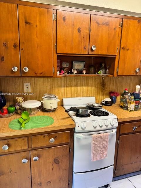 2343 Northwest 28th Street, Unit 12 Oakland Park, FL 33311 - Photo 27 of 34 a kitchen with a stove and a microwave