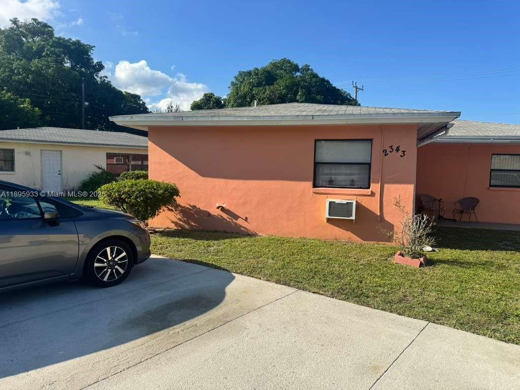 2343 Northwest 28th Street, Unit 12 Oakland Park, FL 33311 - Photo 5 of 34 front view of a house with a yard