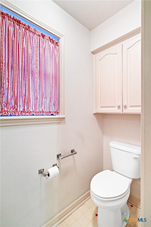603 Suzanne Street Edna, TX 77957 - Photo 19 of 45 a bathroom with a toilet a sink and a window