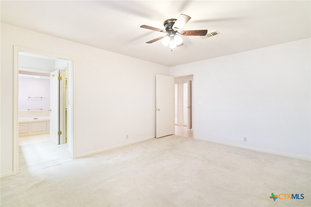 603 Suzanne Street Edna, TX 77957 - Photo 21 of 45 an empty room with fan and a ceiling fan