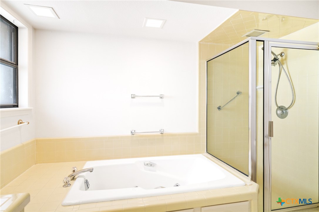 603 Suzanne Street Edna, TX 77957 - Photo 25 of 45 a bathroom with a tub and shower