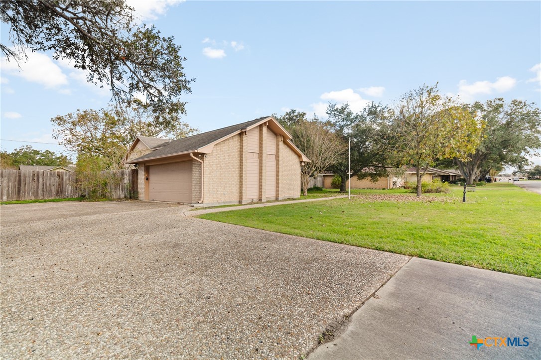 603 Suzanne Street Edna, TX 77957 - Photo 3 of 45 a view of a house with a big yard and large trees