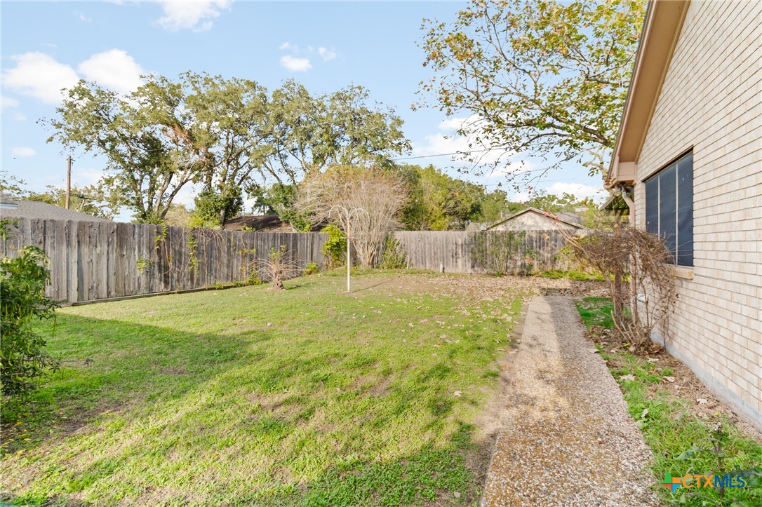 603 Suzanne Street Edna, TX 77957 - Photo 37 of 45 a view of yard with tree