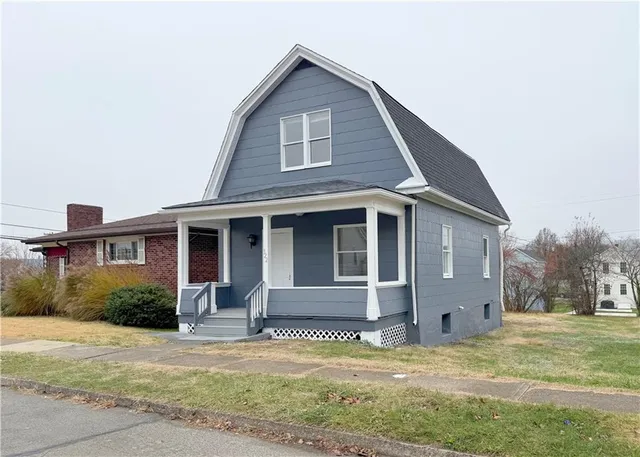 a view of a house with a garden and pathway