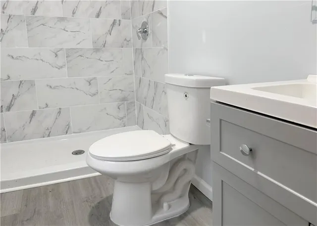 a white toilet sitting next to a bathroom sink
