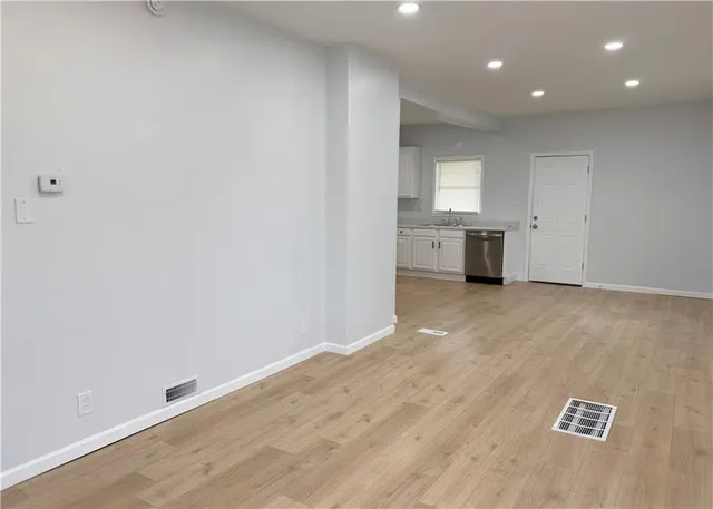 a kitchen with stainless steel appliances granite countertop a sink a stove and a microwave