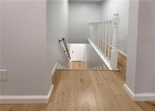 a view of staircase with white walls and a window