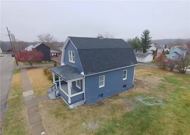 an aerial view of a house with a yard