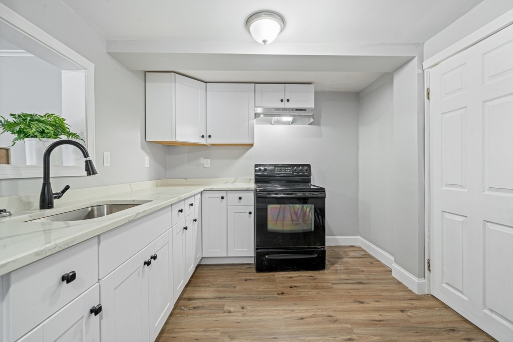124 Cottage Street Athol, MA 01331 - Photo 17 of 38 a kitchen with granite countertop a stove and a sink