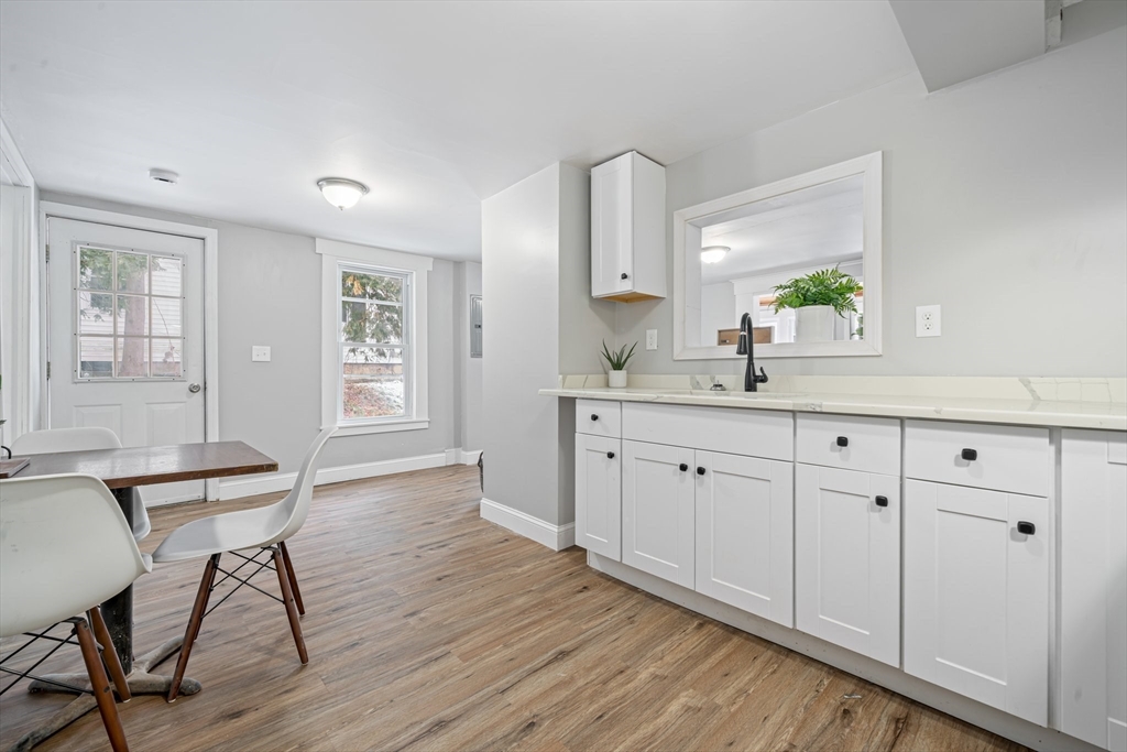 124 Cottage Street Athol, MA 01331 - Photo 18 of 38 a kitchen with a sink cabinets and wooden floor