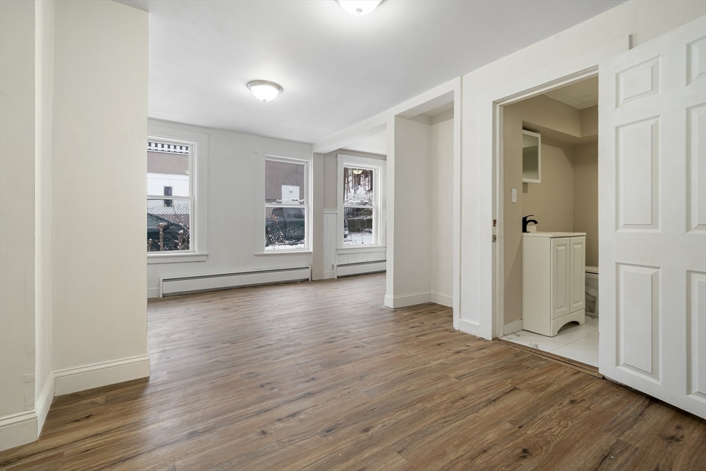 124 Cottage Street Athol, MA 01331 - Photo 27 of 38 an empty room with wooden floor and windows
