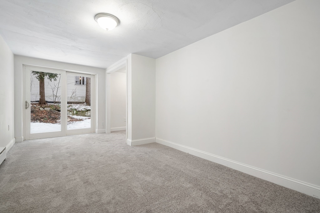 124 Cottage Street Athol, MA 01331 - Photo 36 of 38 an empty room with window and mirror