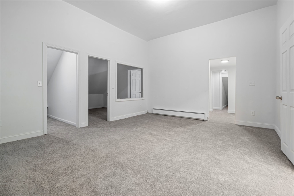 124 Cottage Street Athol, MA 01331 - Photo 8 of 38 an empty room with windows and entrance to other room