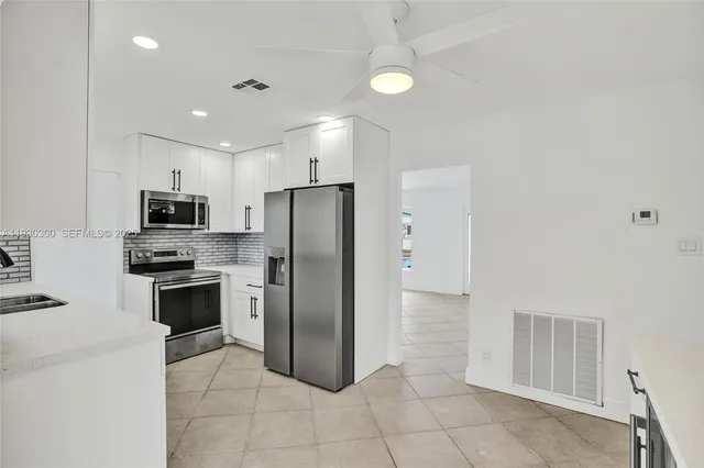 a kitchen with a stove a sink and a refrigerator