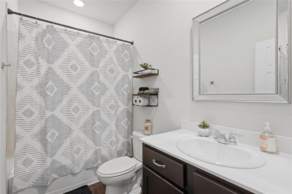 10101 Travis Road Little Elm, TX 75068 - Photo 9 of 26 a bathroom with a sink and a mirror