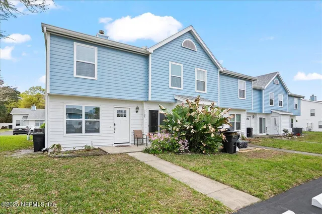 a front view of a house with a garden