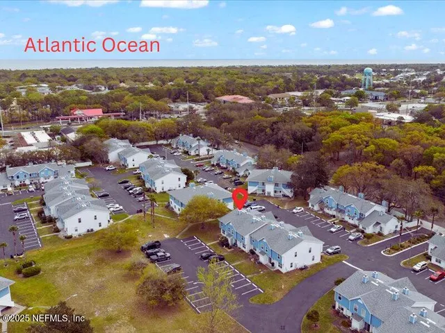 an aerial view of residential houses with outdoor space