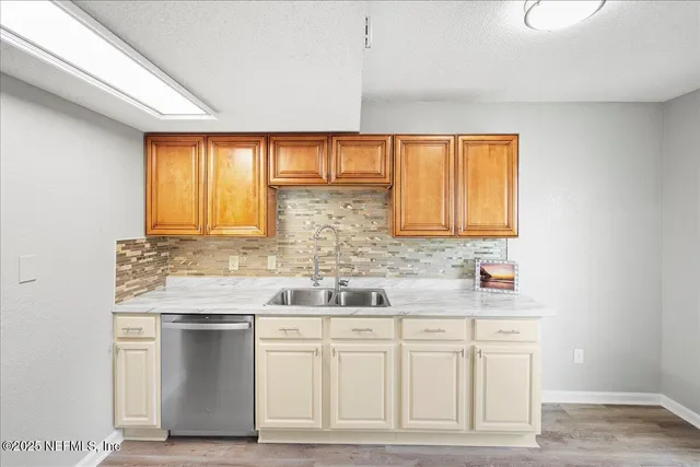 a kitchen with white cabinets and a sink