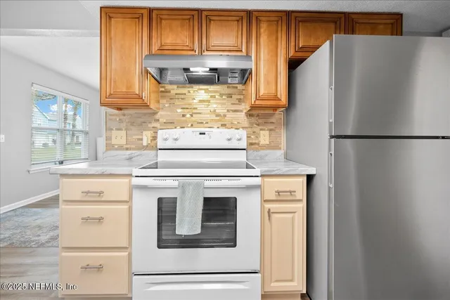 a white refrigerator freezer sitting in a kitchen
