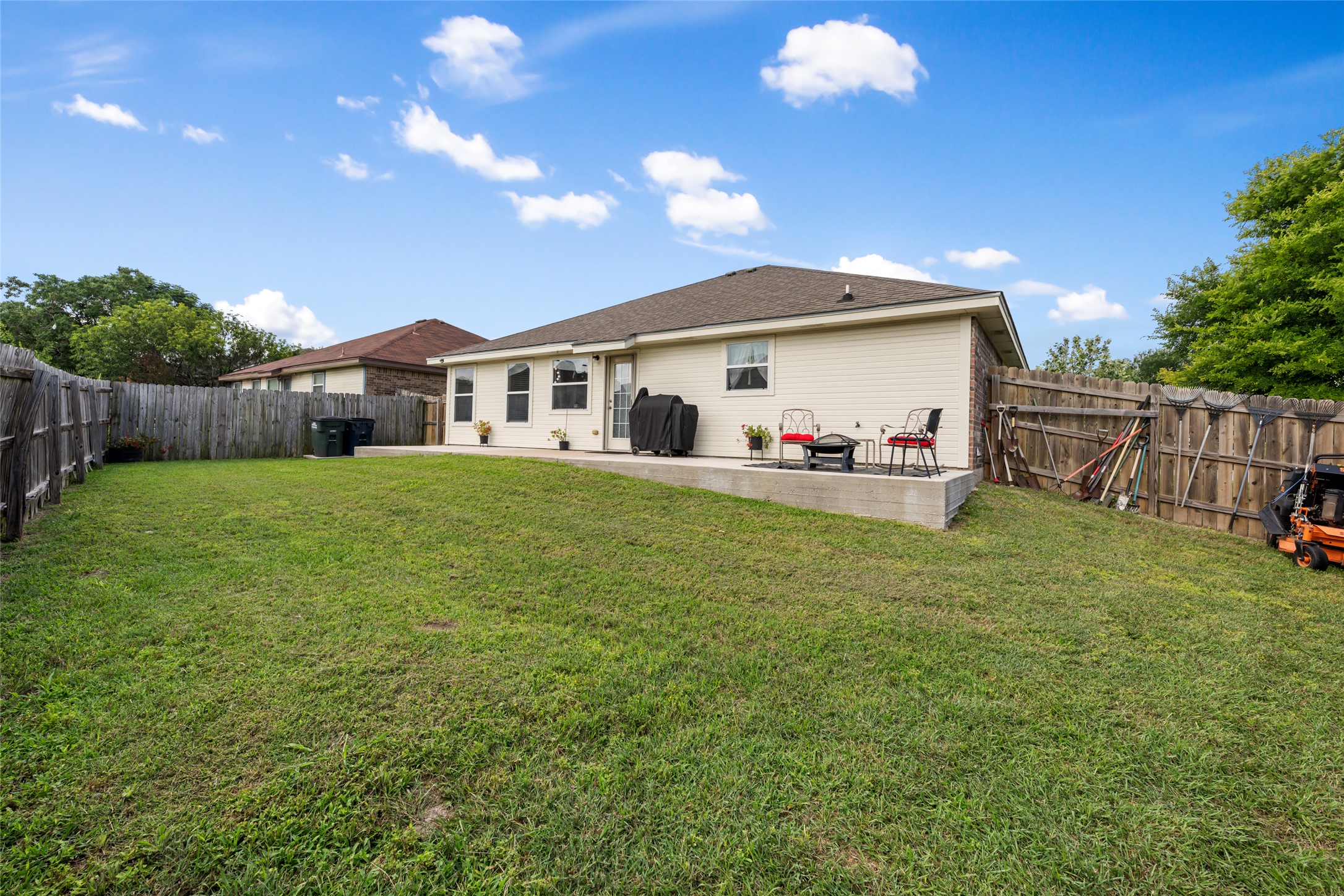 144 Calcite Lane Jarrell, TX 76537 - Photo 33 of 38 A spacious yard perfect for entertaining, with a private fenced area and an inviting patio.