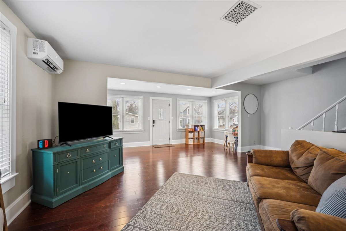 128 North Hadsall Street Genoa, IL 60135 - Photo 2 of 21 a living room with furniture and a flat screen tv