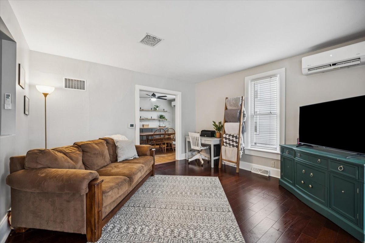 128 North Hadsall Street Genoa, IL 60135 - Photo 3 of 21 a living room with furniture and a flat screen tv