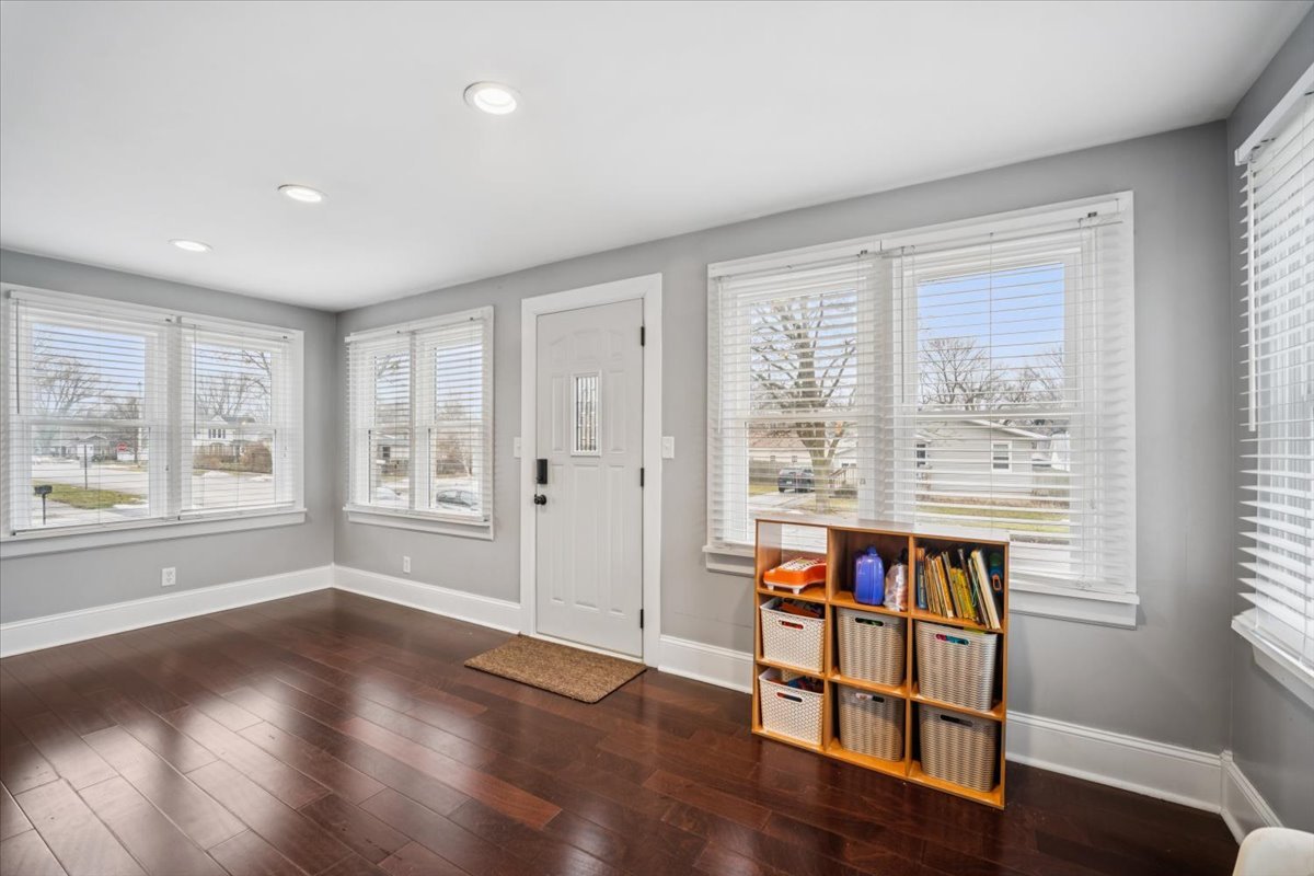 128 North Hadsall Street Genoa, IL 60135 - Photo 4 of 21 an empty room with wooden floor and a window