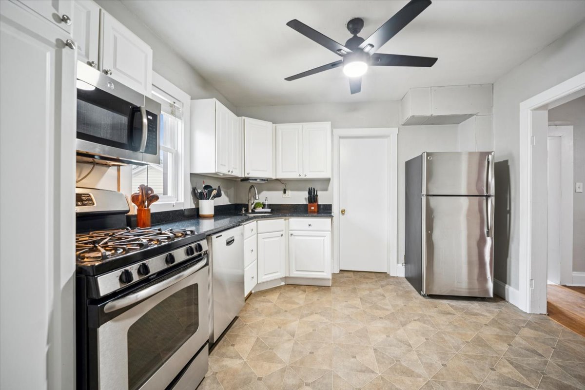 128 North Hadsall Street Genoa, IL 60135 - Photo 6 of 22 a kitchen with stainless steel appliances granite countertop a refrigerator stove microwave and sink