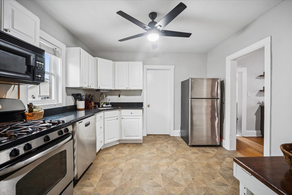 128 North Hadsall Street Genoa, IL 60135 - Photo 7 of 21 a kitchen with stainless steel appliances granite countertop a refrigerator stove and microwave
