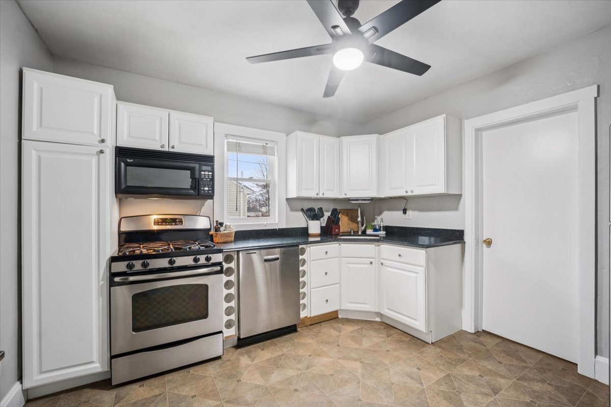 128 North Hadsall Street Genoa, IL 60135 - Photo 8 of 21 a kitchen with stainless steel appliances a stove a sink and white cabinets