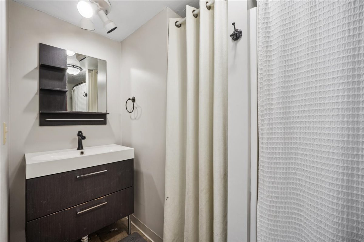 128 North Hadsall Street Genoa, IL 60135 - Photo 10 of 21 a bathroom with a double vanity sink and mirror