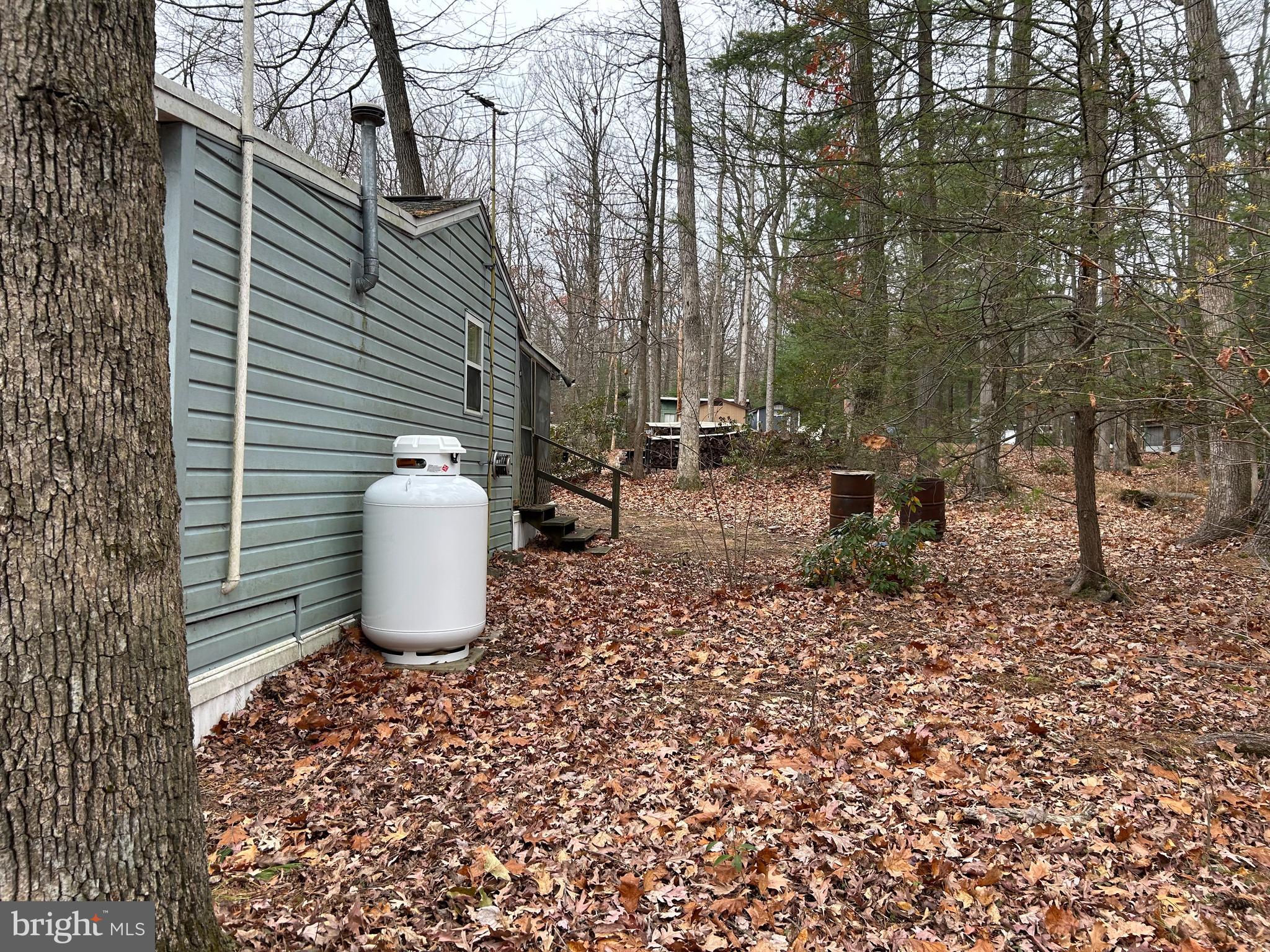 30 Pine Tree Trail Orrtanna, PA 17353 - Photo 4 of 12 a view of a backyard with table and chairs and a barbeque