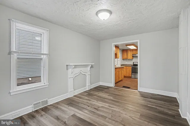 a view of a room with wooden floor and a window