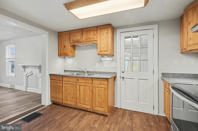 a spacious bathroom with a granite countertop sink and a mirror