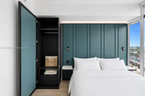 a bedroom with a bed and a mirror